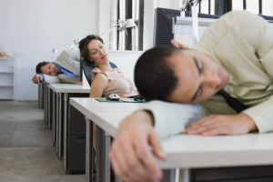 Businesspeople Sleeping on Desks